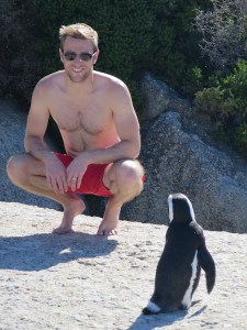 Rich being carefully watched by a penguin