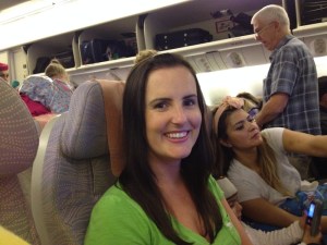 Sonia trying to keep a smile on her face while being seated next to a three year old