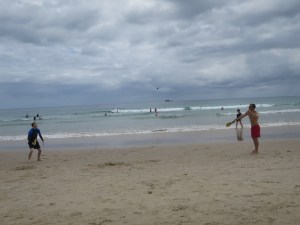 Tom and Rich playing bat and ball on the beach