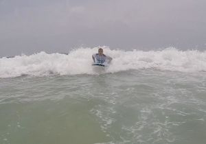Rich inbound on his surfboard