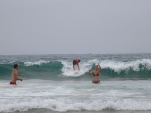 Rich and Sonia playing catch in the sea at Bondi beach