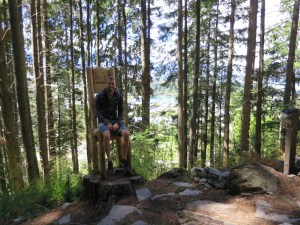 Rich enjoying a break from walking on one of the chairs carved from a tree