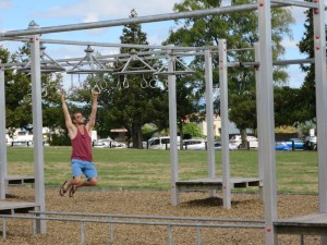 Rich playing on the outdoor gym equipment