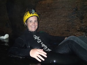 Sonia smiling through the dark caves