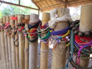 Friendship bracelets left by visitors on the fence of the mass graves