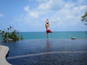 Rich in tree pose overlooking the ocean