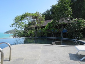 The yoga sala in the shade of the trees behind the pool