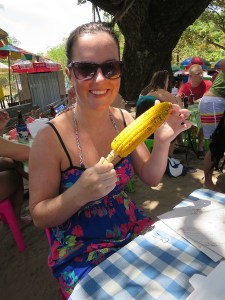 Sonia enjoying corn for lunch by the beach