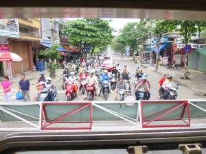 Scooters waiting for the railway crossing to open