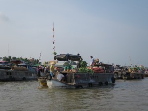 Boat selling vegetables as seen hanging from the bamboo pole