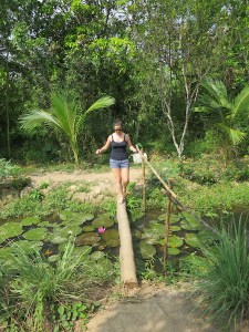 Sonia walking across the small bridge